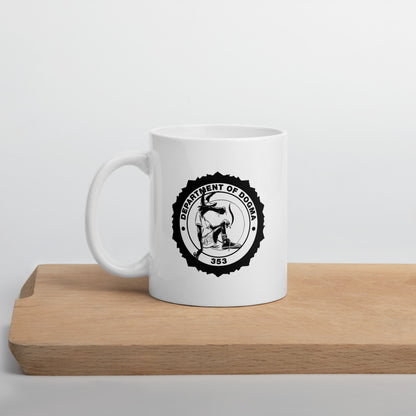 White mug with a black logo on a wooden surface