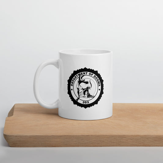 White mug with a black logo on a wooden surface